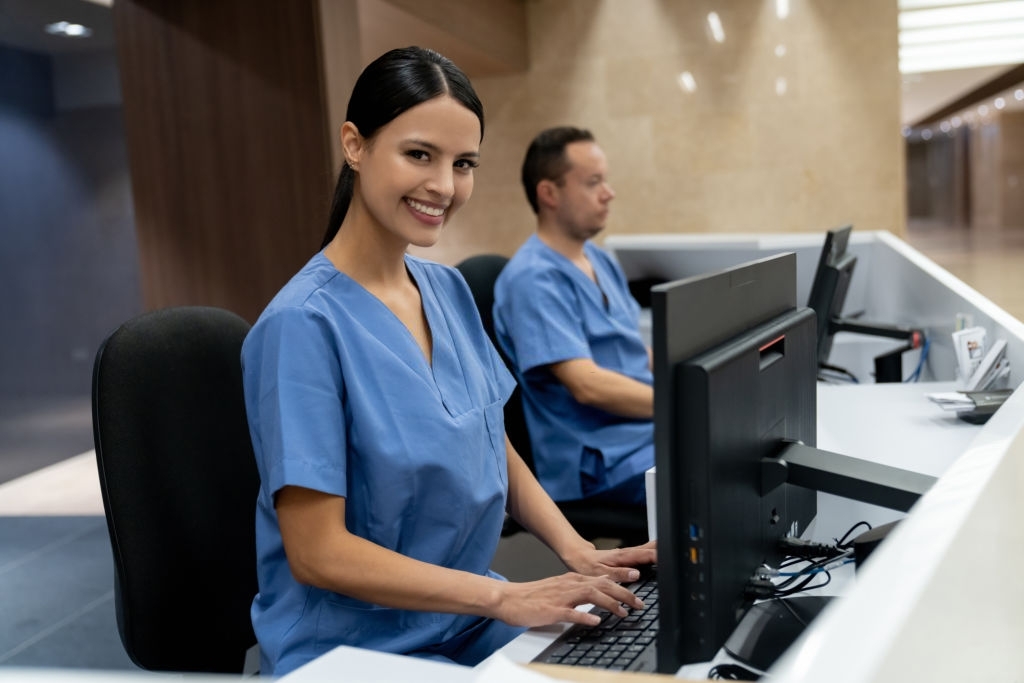 Hospital Administrators working at a hospital and looking at the camera smiling